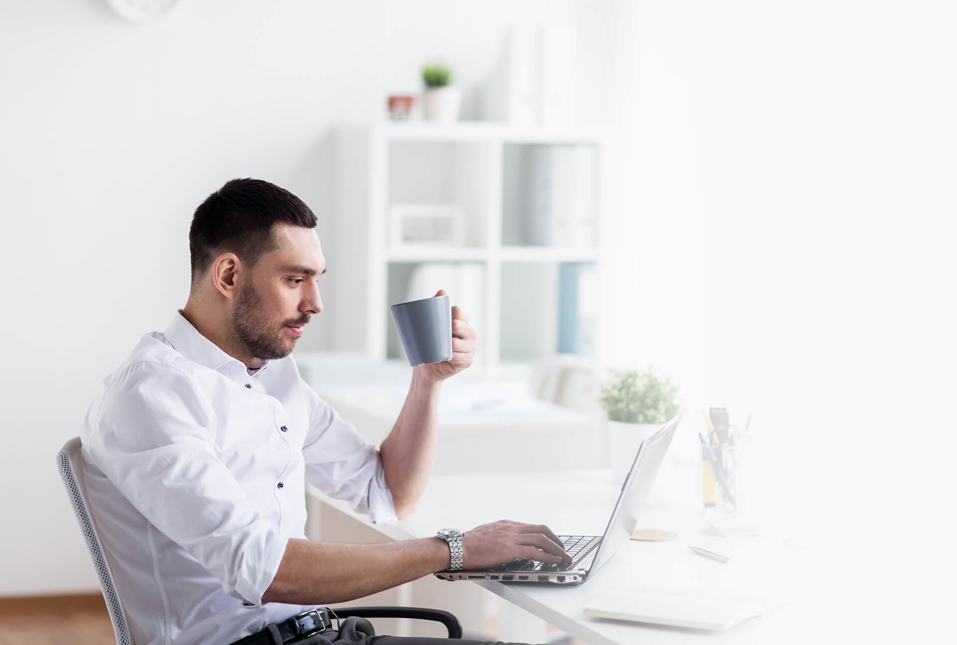 Guy having Coffee at his desk