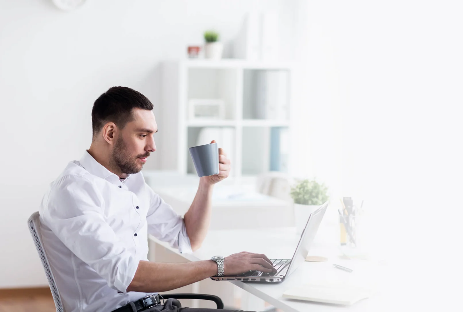 Guy having Coffee at his desk